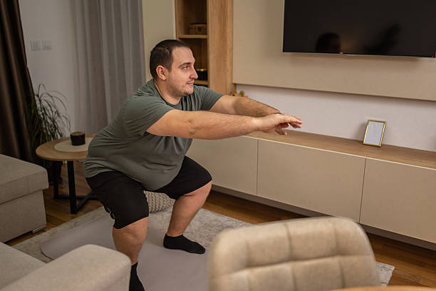 Person doing a bodyweight squat in a cosy living room
